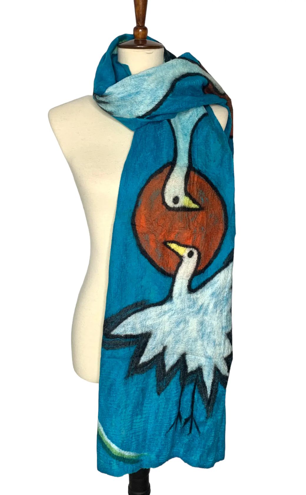 Pomegranate Moon Crane hand-felted silk and wool scarf with white cranes and rust red sun on turquoise, displayed on a dress form