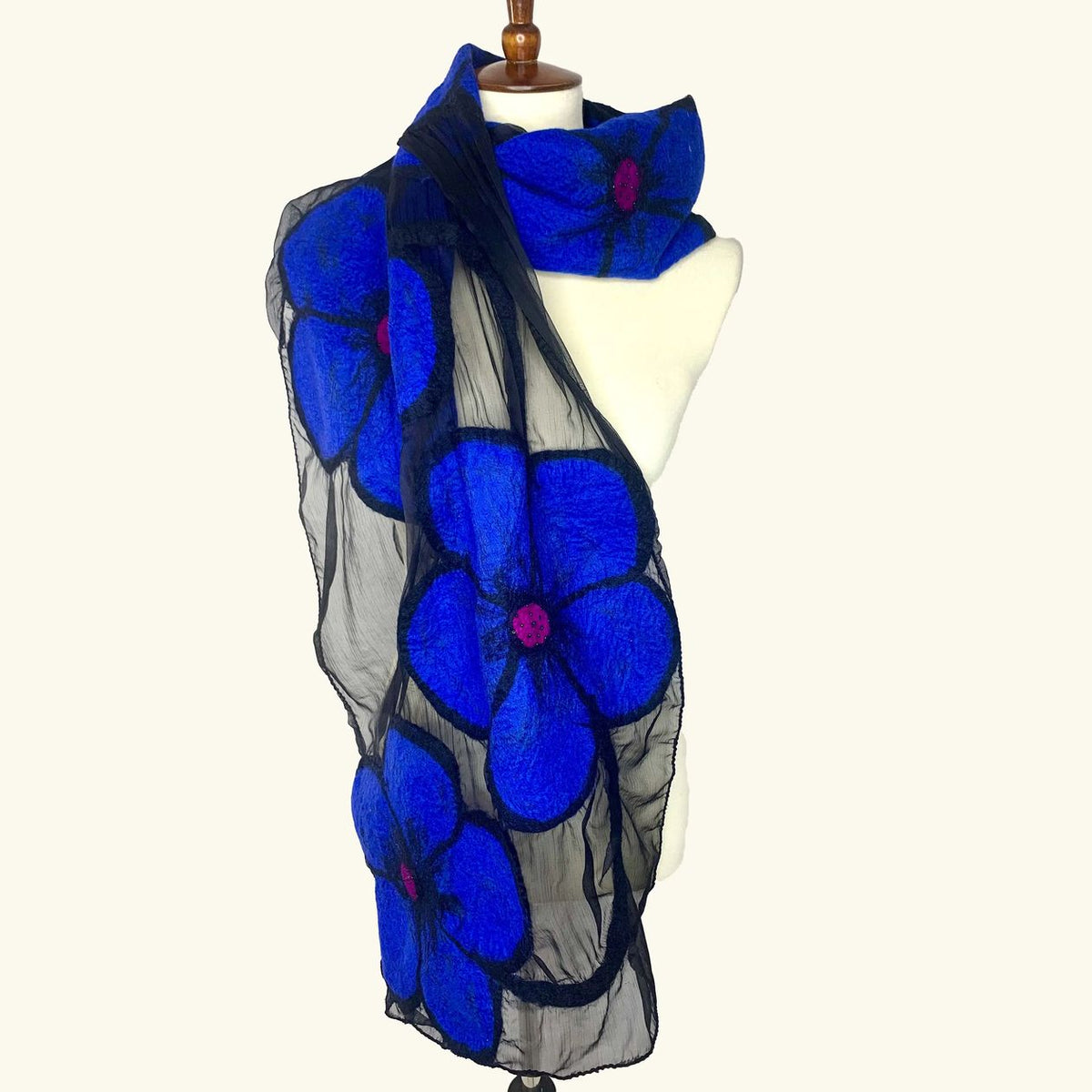 Pomegranate Moon Midnight Flower hand-felted silk and wool scarf with cobalt blue flowers on sheer black, displayed on a dress form