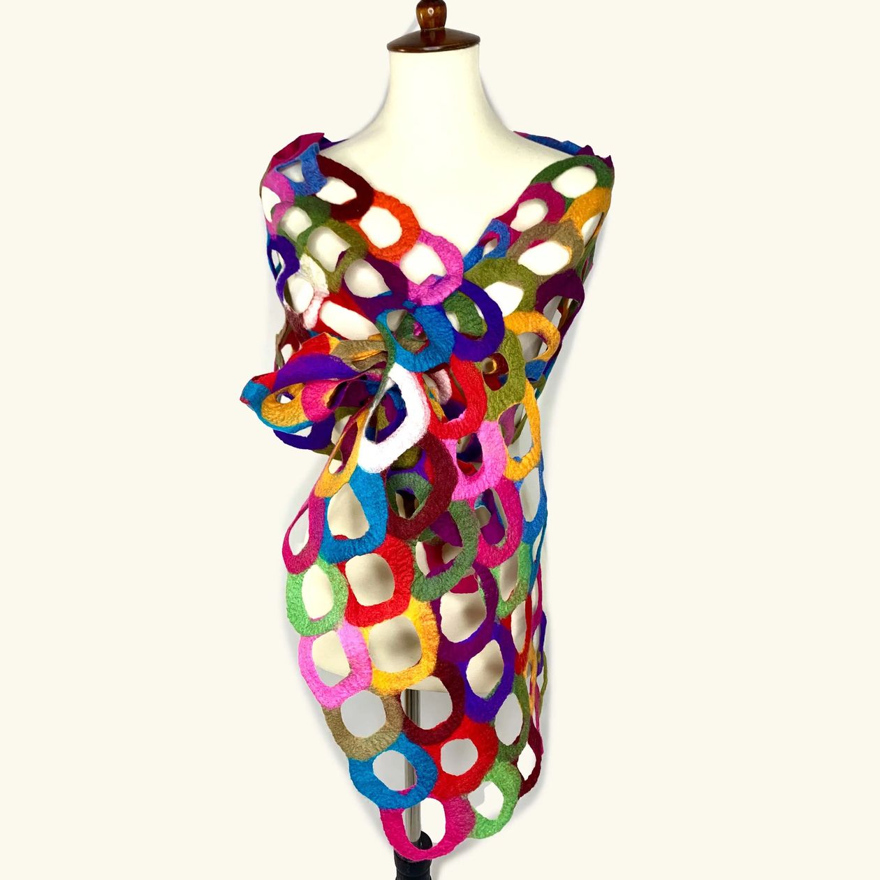 Pomegranate Moon Ring hand-felted scarf made of interlocking multicolor rings in an open lattice, displayed on a dress form
