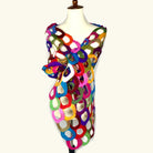 Pomegranate Moon Ring hand-felted scarf made of interlocking multicolor rings in an open lattice, displayed on a dress form