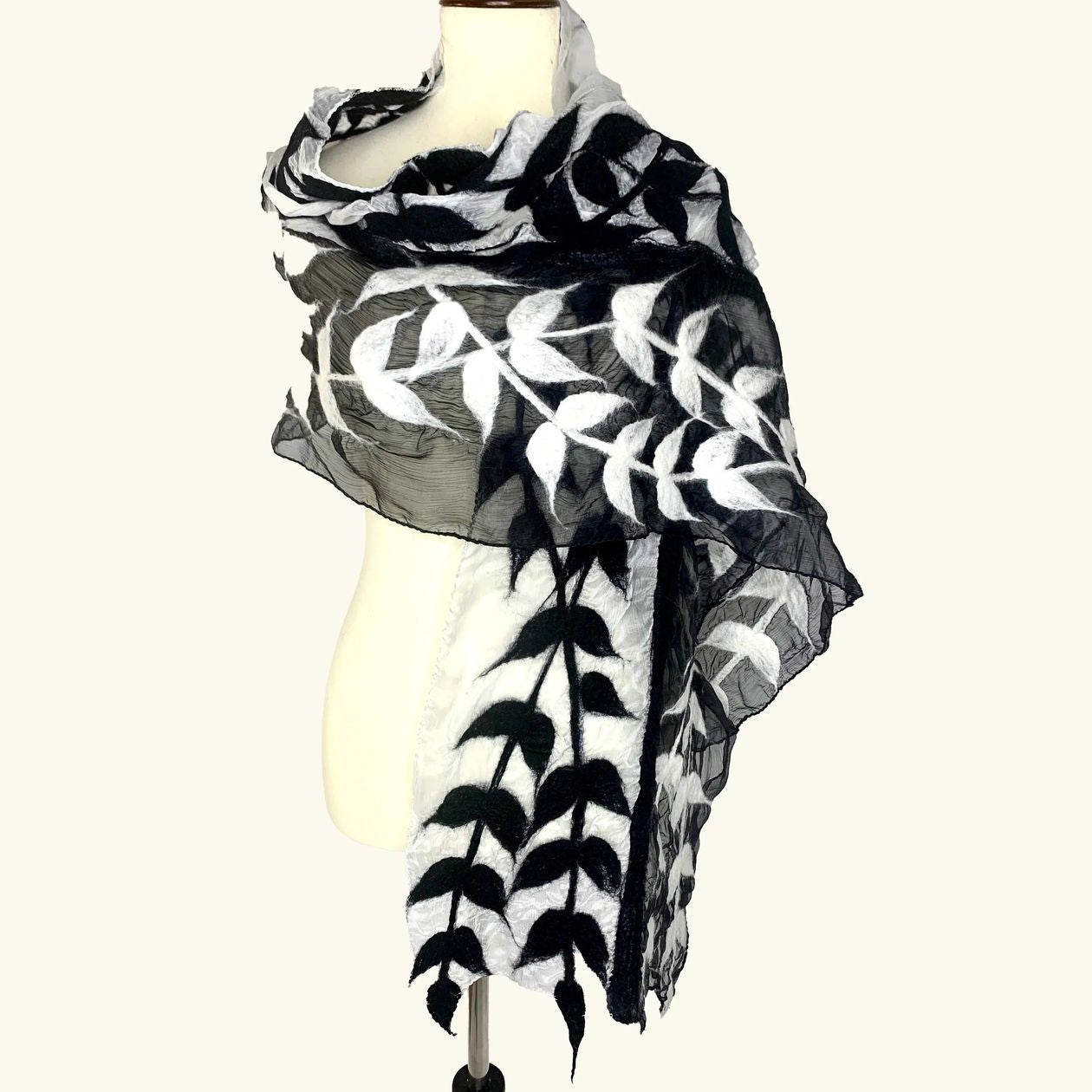 Pomegranate Moon Split Vine hand-felted silk and wool scarf with black and white vine leaves on gray, displayed on a dress form