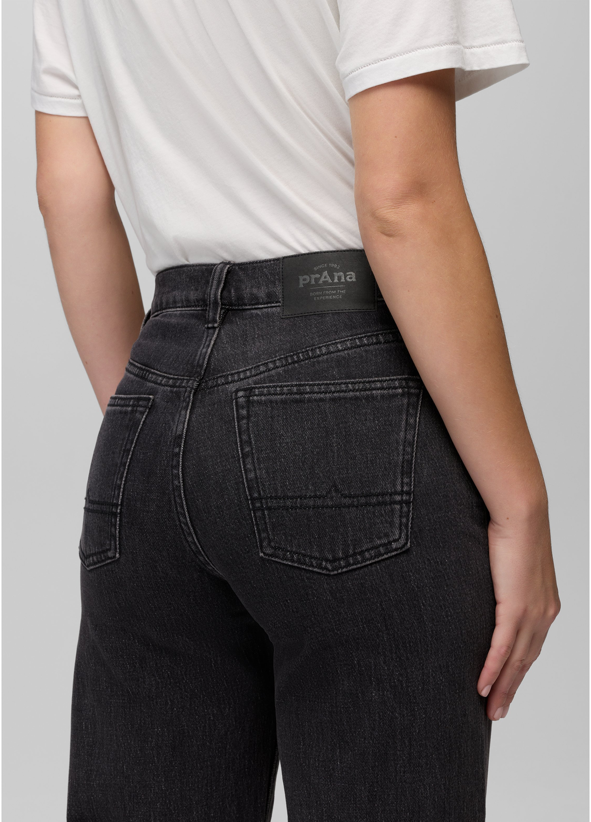 Back view of the prAna Carlsbad High Rise Wide Leg jeans in Black Sand showing the high rise waistband and back patch pockets