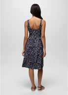 Woman wearing a sleeveless dress with a pattern on a white background