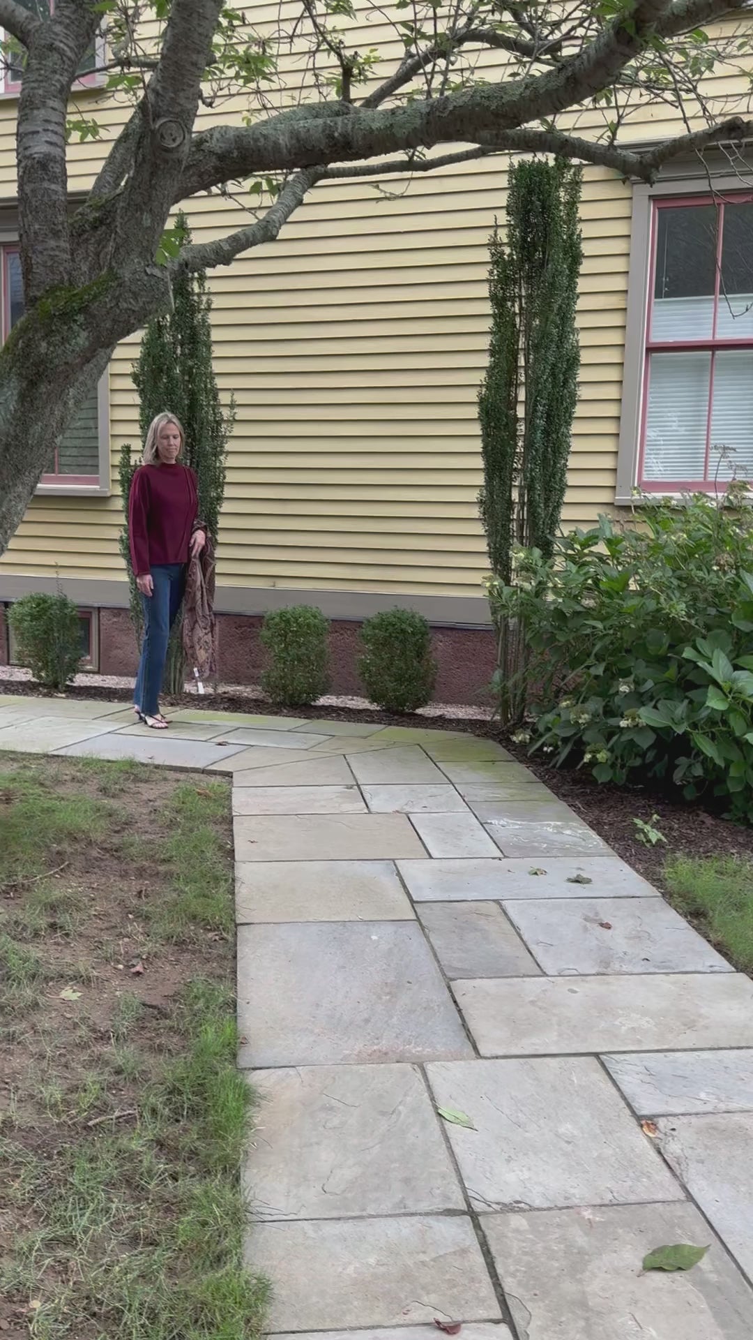 video of model walking in embroidered wool scarf jeans and trish tyler mockneck