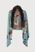 Light blue Bloom scarf styled open over a sweater
