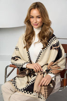 Checkered equestrian wrap styled over a white turtleneck
