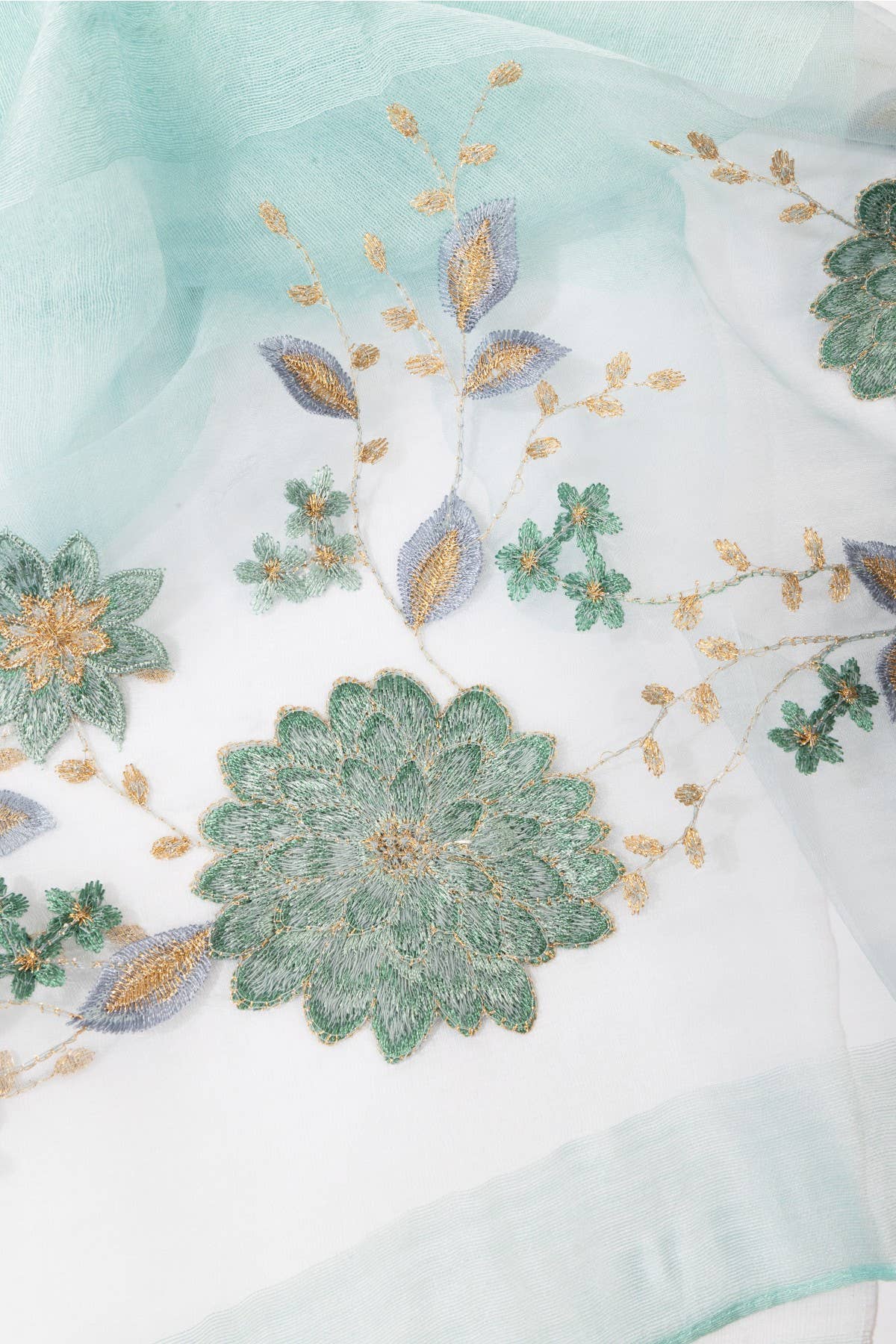 Aqua sheer scarf laid flat showing the floral embroidery