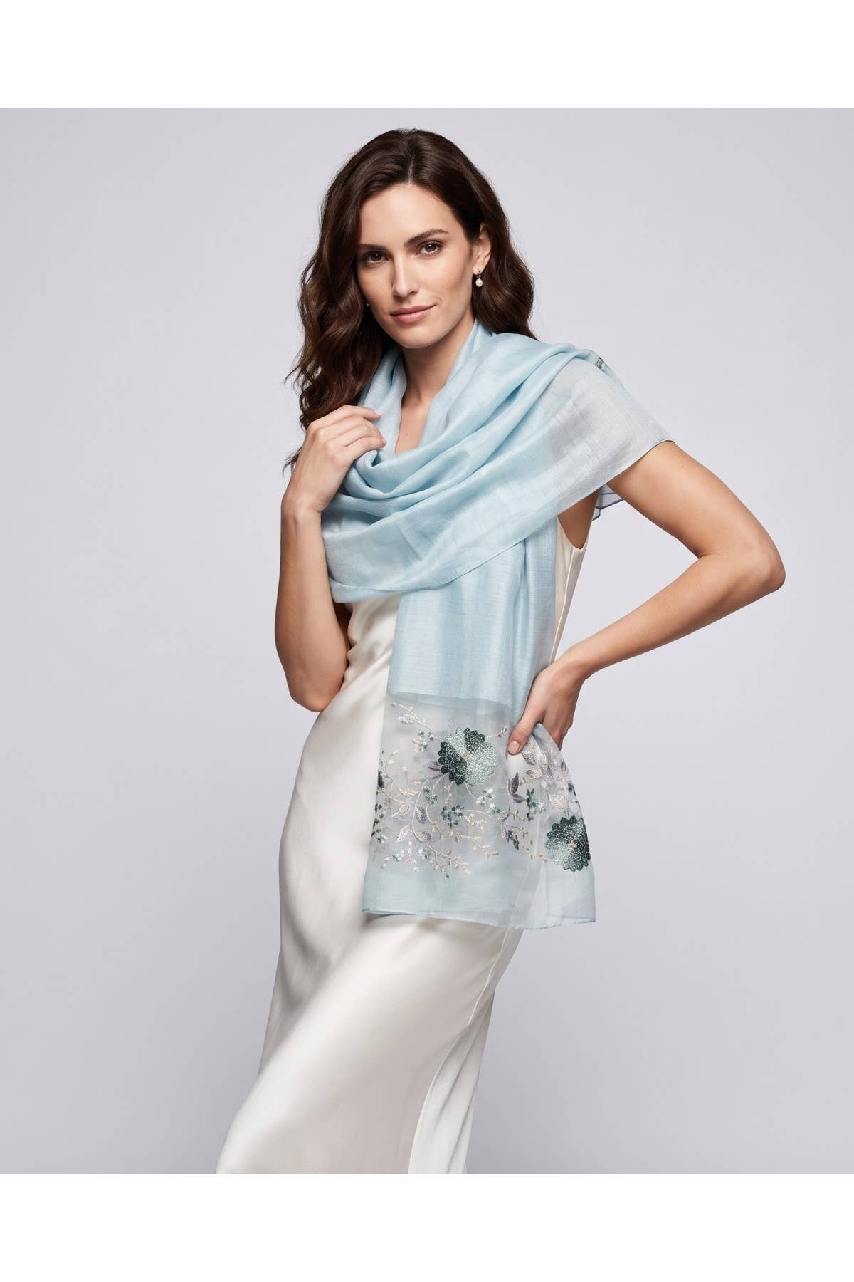 Aqua floral embroidered sheer scarf worn over the shoulders