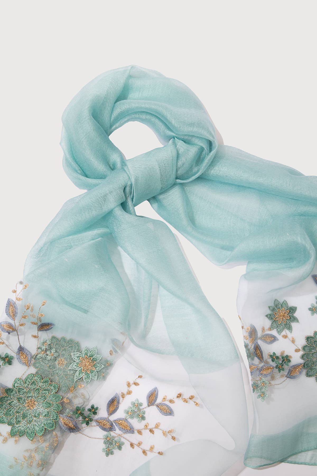 Woman wearing the aqua embroidered sheer scarf