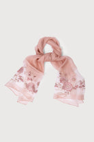 Close-up of floral embroidery on the blush pink sheer scarf