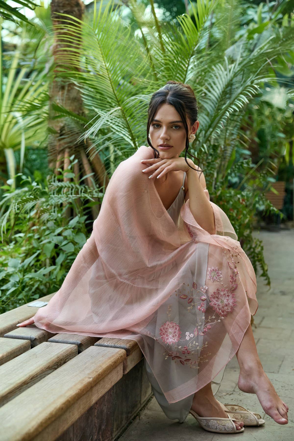 Blush pink floral embroidered sheer scarf worn over the shoulders