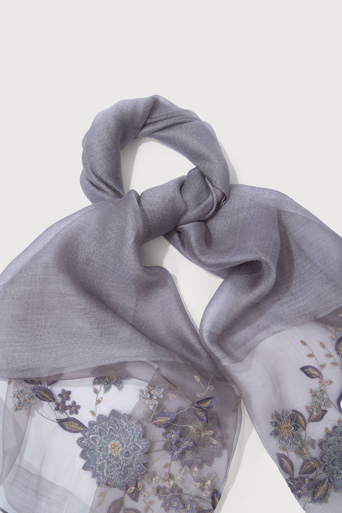 Grey sheer scarf laid flat showing the floral embroidery