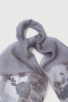 Grey sheer scarf laid flat showing the floral embroidery