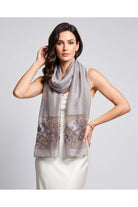 Grey floral embroidered sheer scarf worn over the shoulders