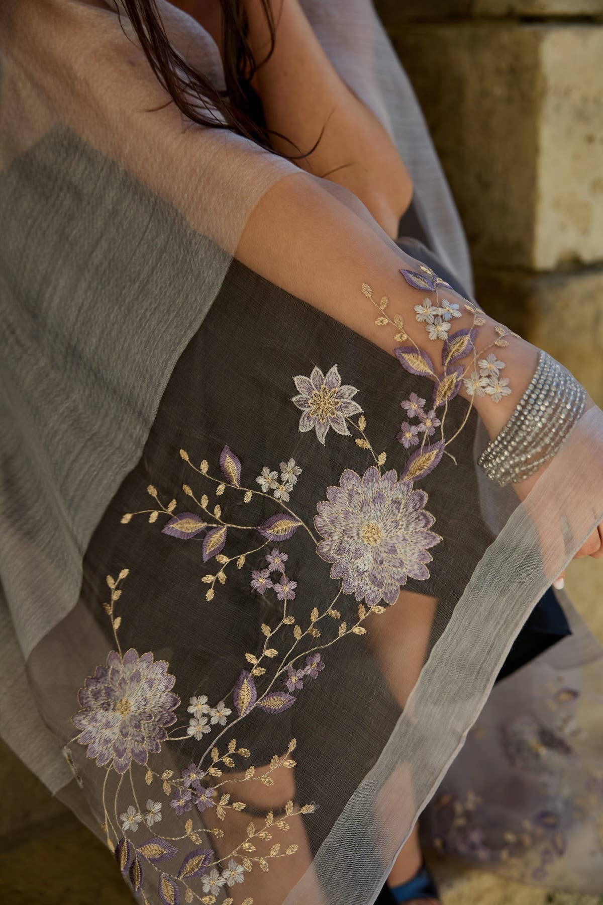 Grey floral embroidered scarf styled as a wrap