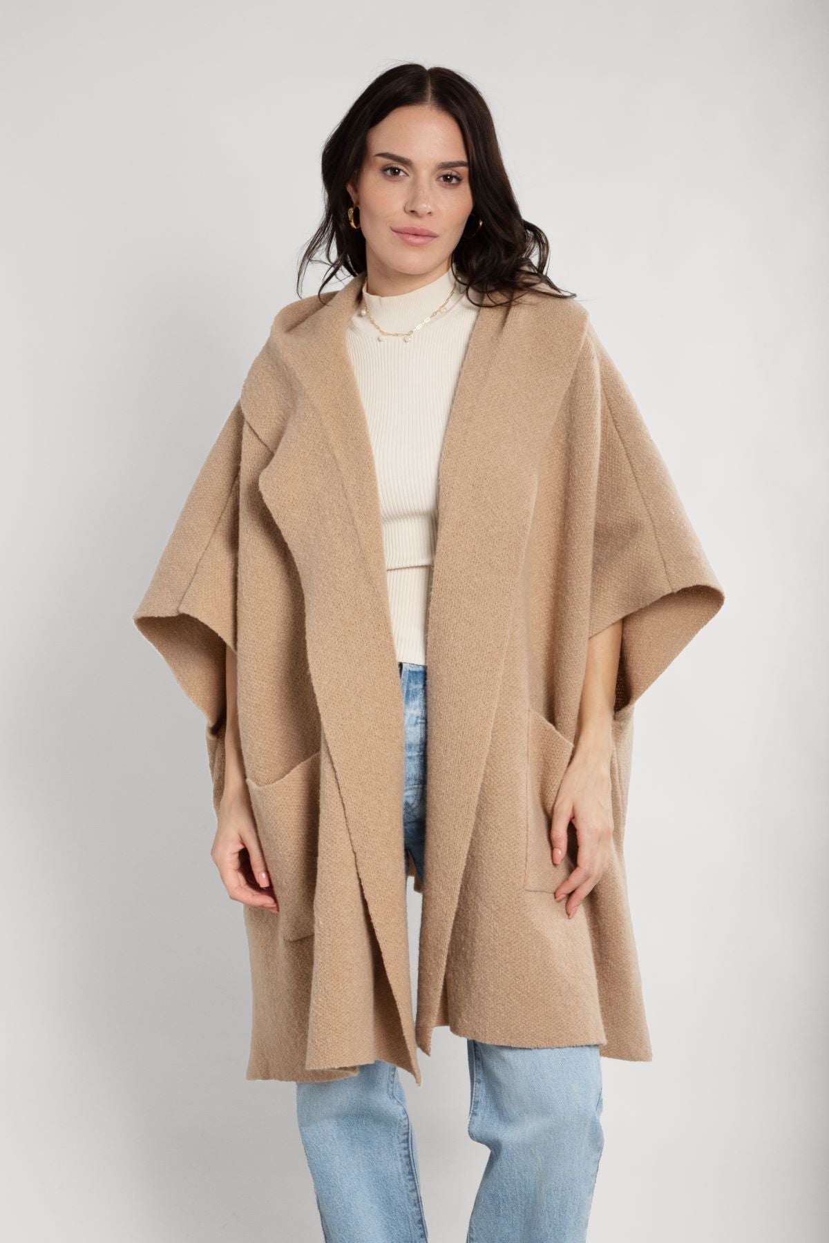Light hooded oversized kimono with front pockets worn over jeans