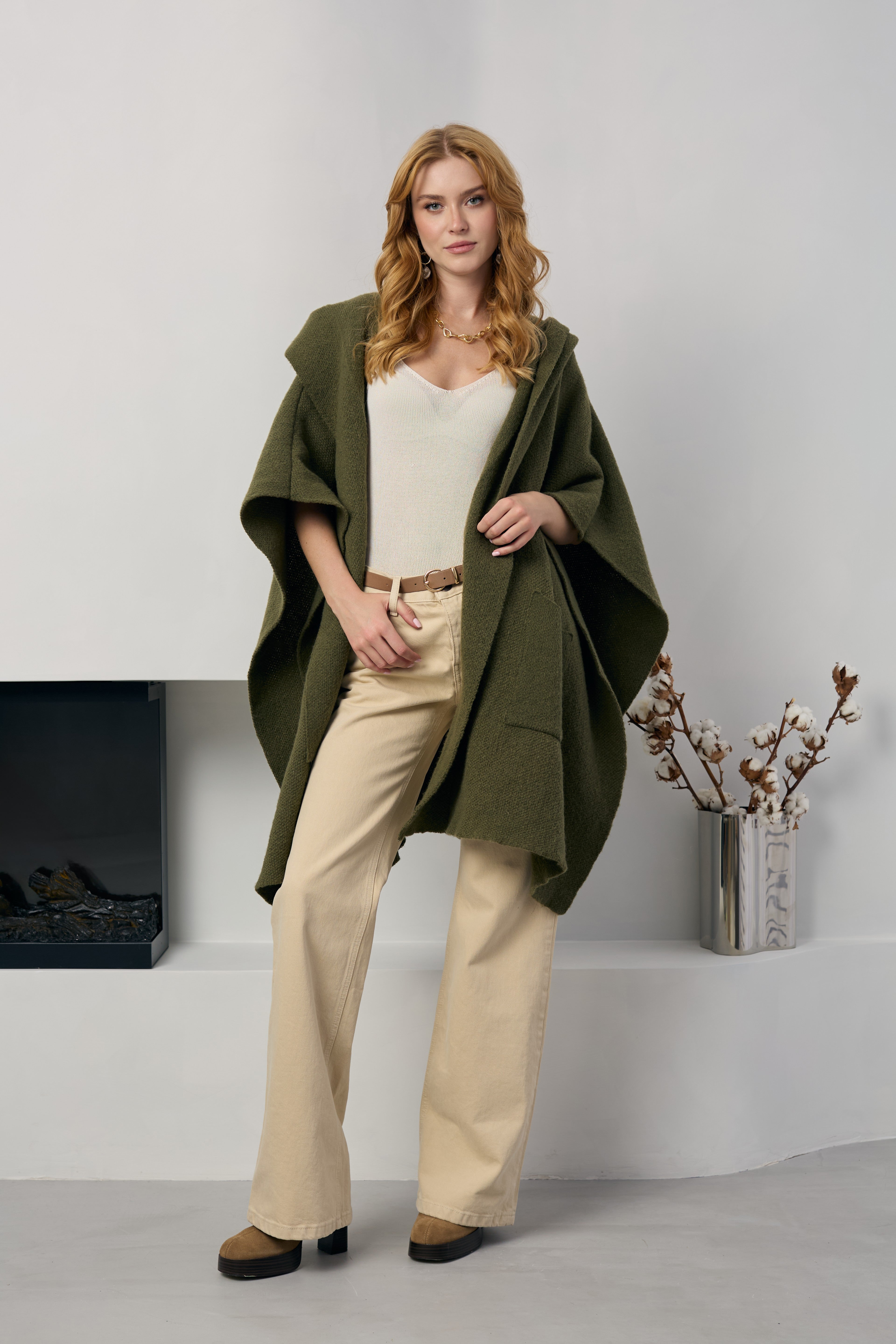 Olive hooded oversized kimono worn open over a cream top and trousers