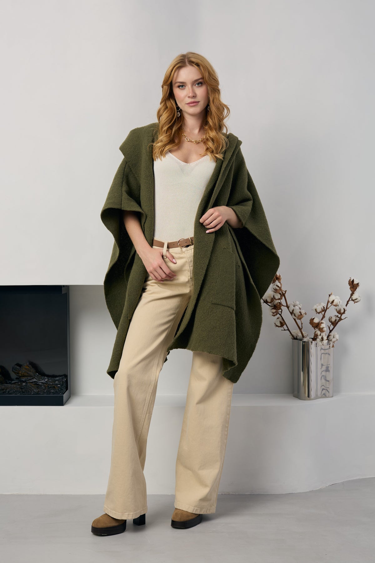 Olive hooded oversized kimono worn open over a cream top and trousers