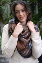 Plaid triangle shawl knotted at the neck