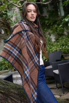 Brown plaid knitted triangle shawl worn over the shoulders