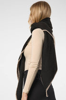 Black knitted triangle shawl styled outdoors