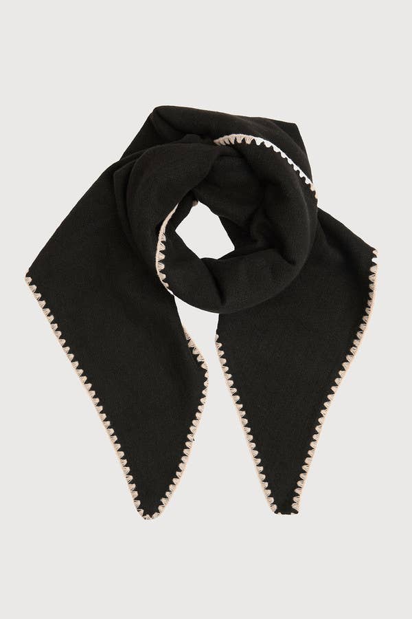 Black knitted triangle shawl knotted at the neck