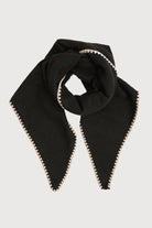 Black knitted triangle shawl knotted at the neck