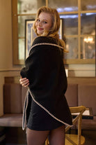 Woman wearing the black knitted triangle shawl