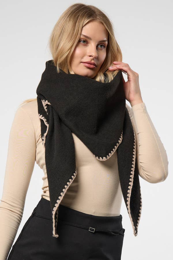 Black knitted triangle shawl worn over the shoulders