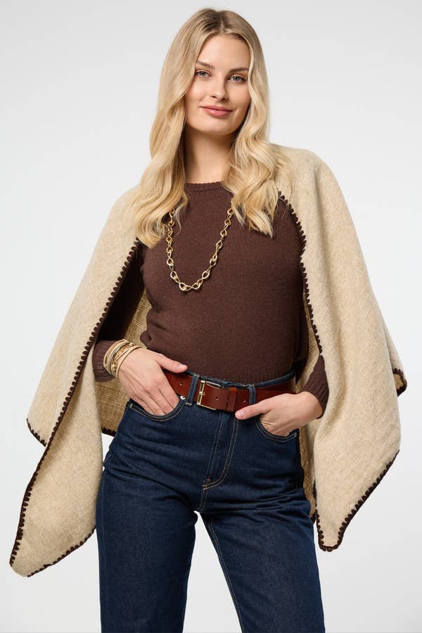 Ivory knitted triangle shawl worn over the shoulders
