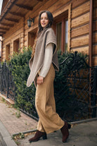 Taupe knitted triangle shawl styled outdoors