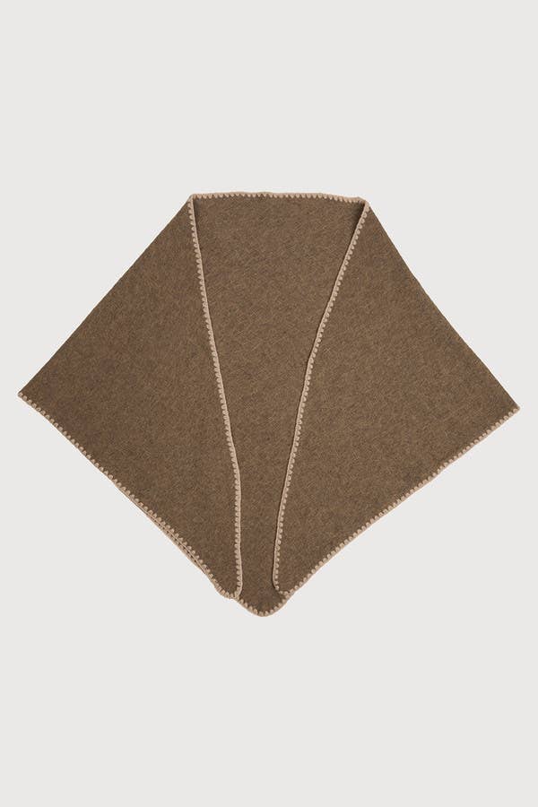 Taupe knitted triangle shawl laid flat with whipstitch edge