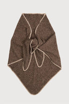 Woman wearing the taupe knitted triangle shawl