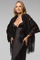 Black lace shimmer scarf draped over the shoulders