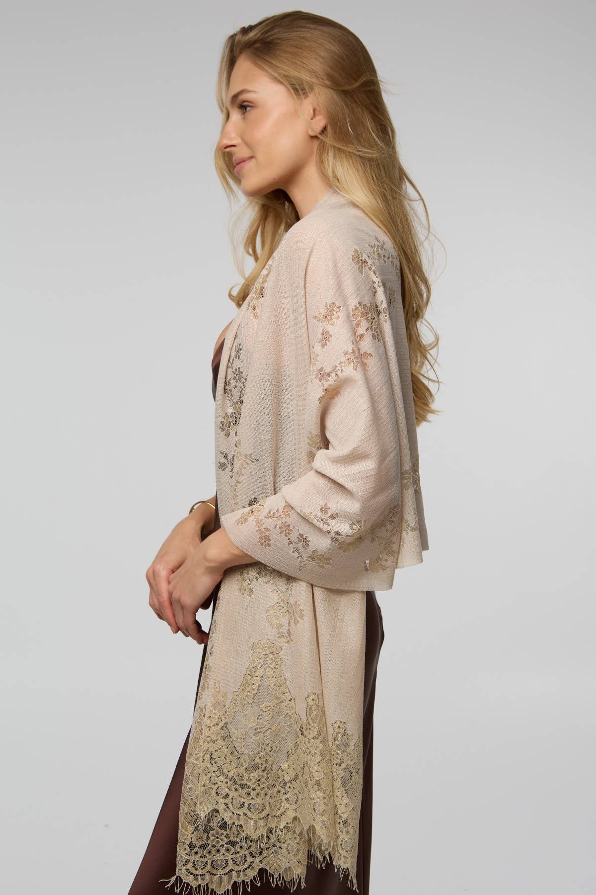 Cream lace scarf worn as a wrap