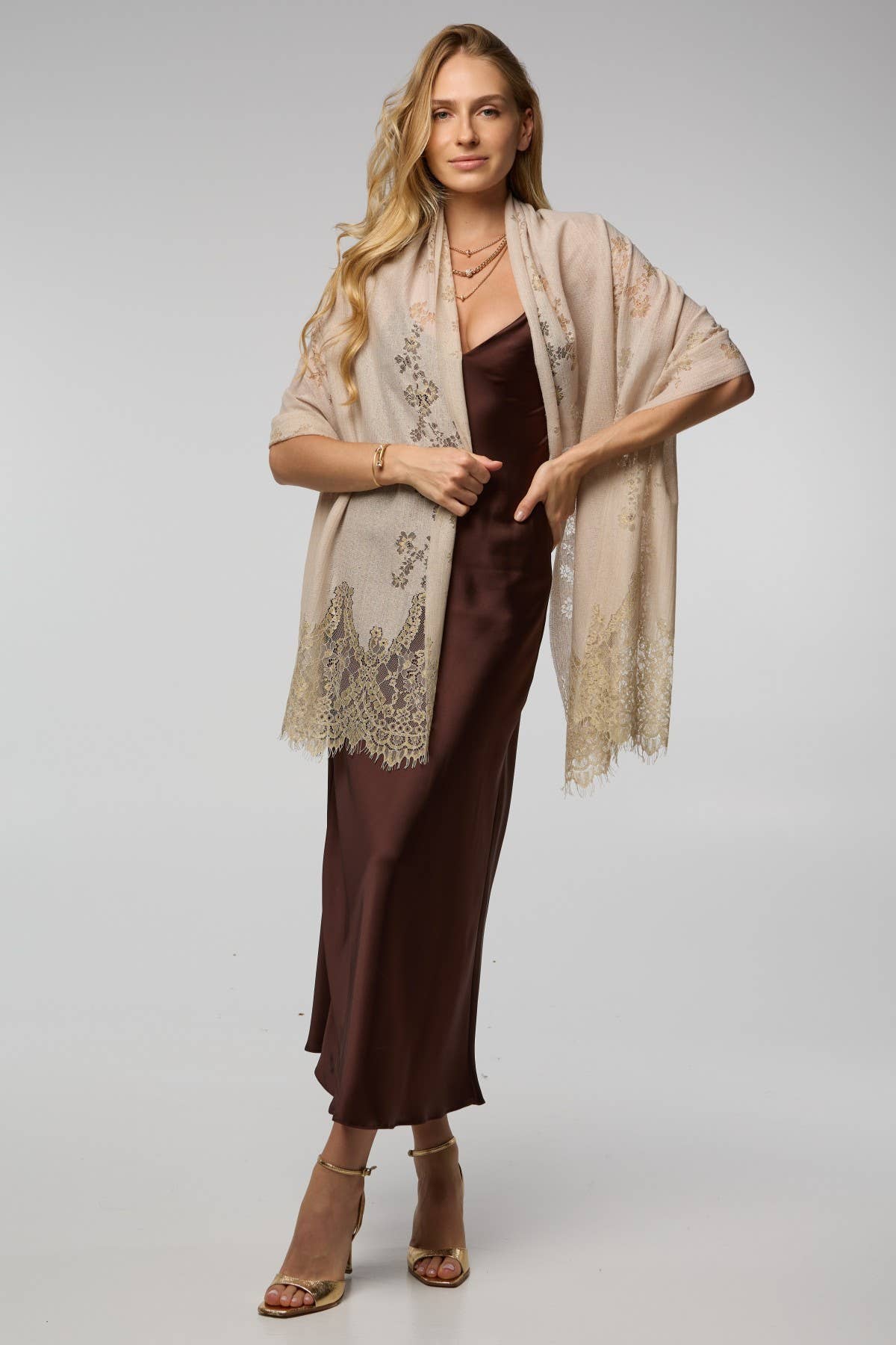 Cream lace shimmer scarf draped over the shoulders