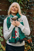Woman wearing the green and cream Mahjong reversible scarf