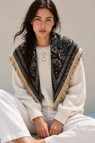 Navy paisley fringe scarf worn over a cream sweater