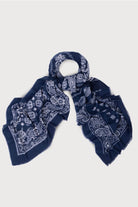 Navy paisley scarf knotted at the neck