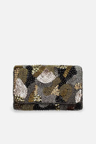 A rectangular clutch bag covered in intricate beadwork and sequin embroidery, featuring a pattern of black, gold, and silver tones, set against a plain light gray background.