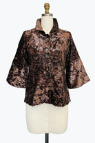A brown sequined jacket with a textured, distressed pattern, featuring a stand collar and three-quarter sleeves, displayed on a cream dress form mannequin against a white background.