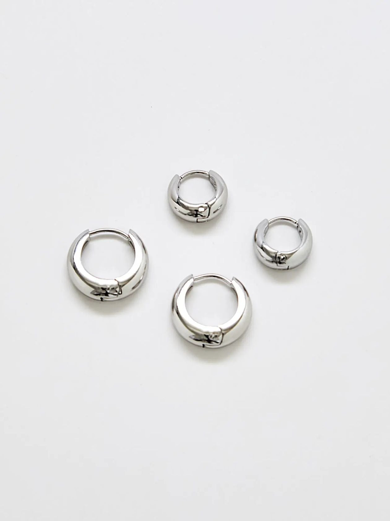 Silver medium hoop earrings, two-pack, on a white background