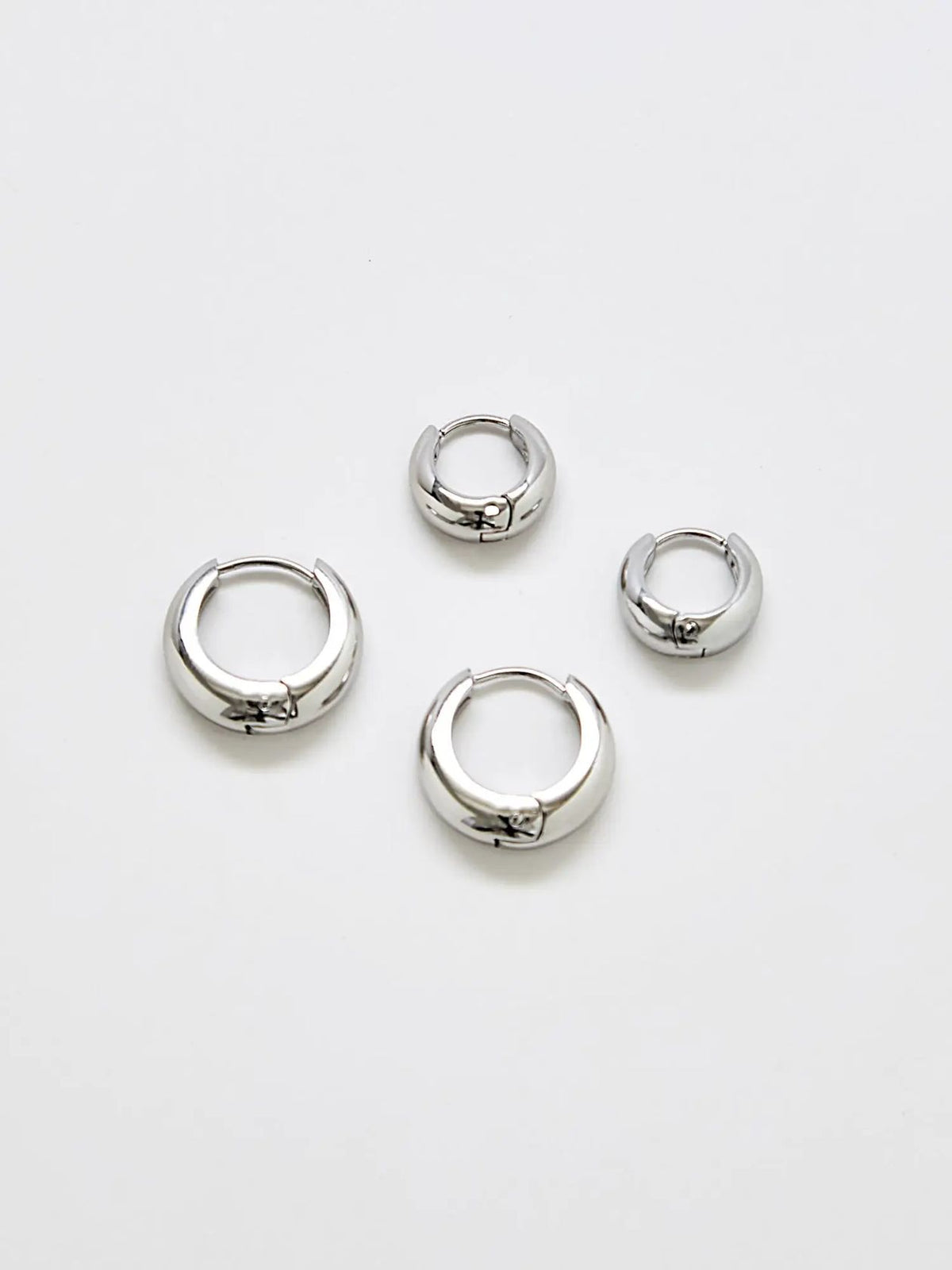 Silver medium hoop earrings, two-pack, on a white background