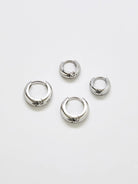 Silver medium hoop earrings, two-pack, on a white background