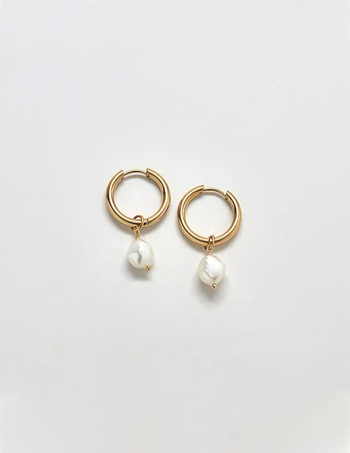 Single freshwater pearl huggie hoop earring on a white background