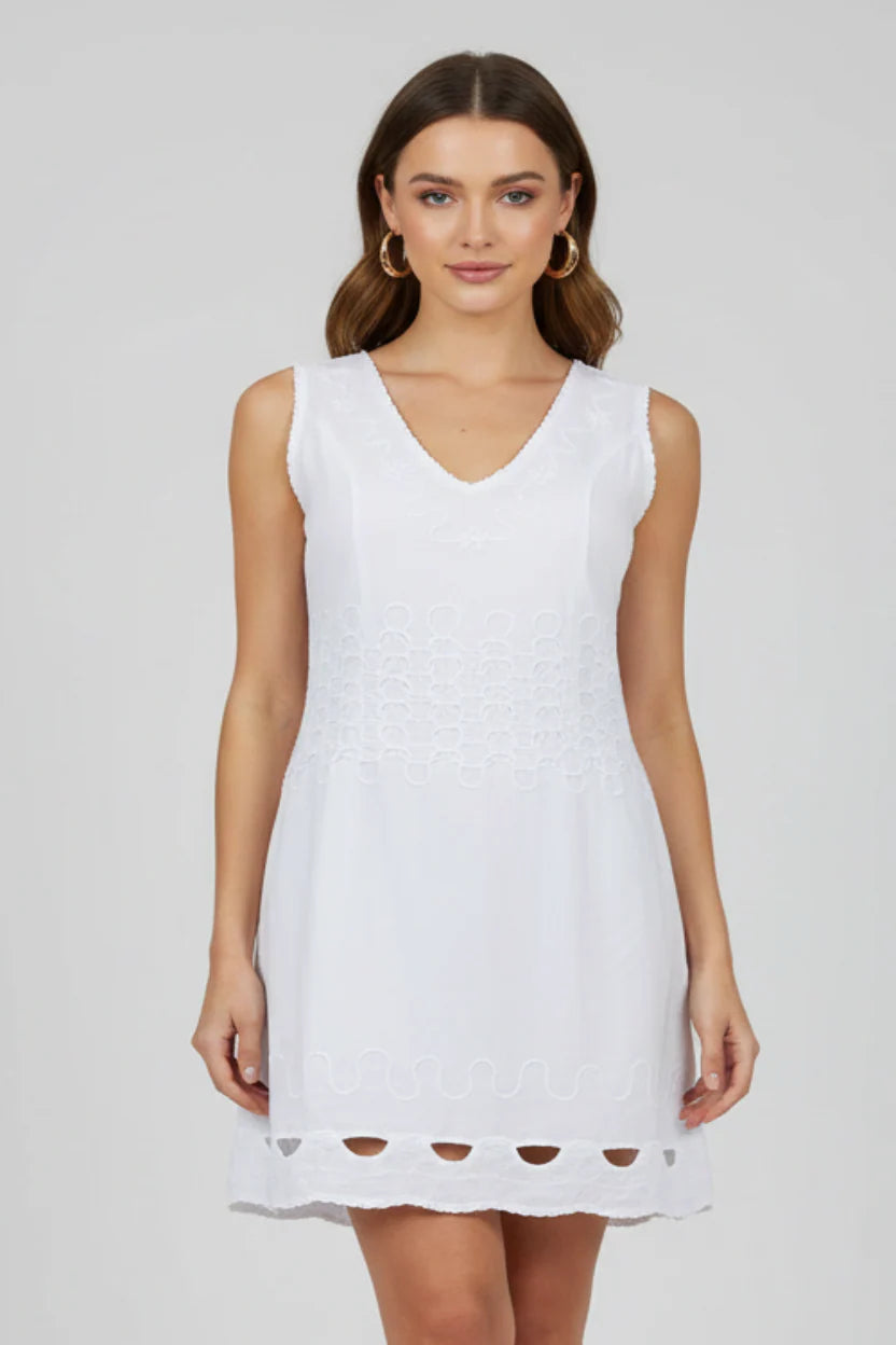 Woman wearing a white sleeveless dress on a plain background