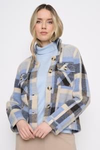 A woman wearing a light blue mock-neck top and a blue, beige, and gray plaid cropped jacket with large decorative buttons, set against a plain white background.
