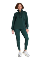 SPANX AirEssentials Brushed Half Zip Tunic in Meridian deep green, full-length front view with leggings and sneakers