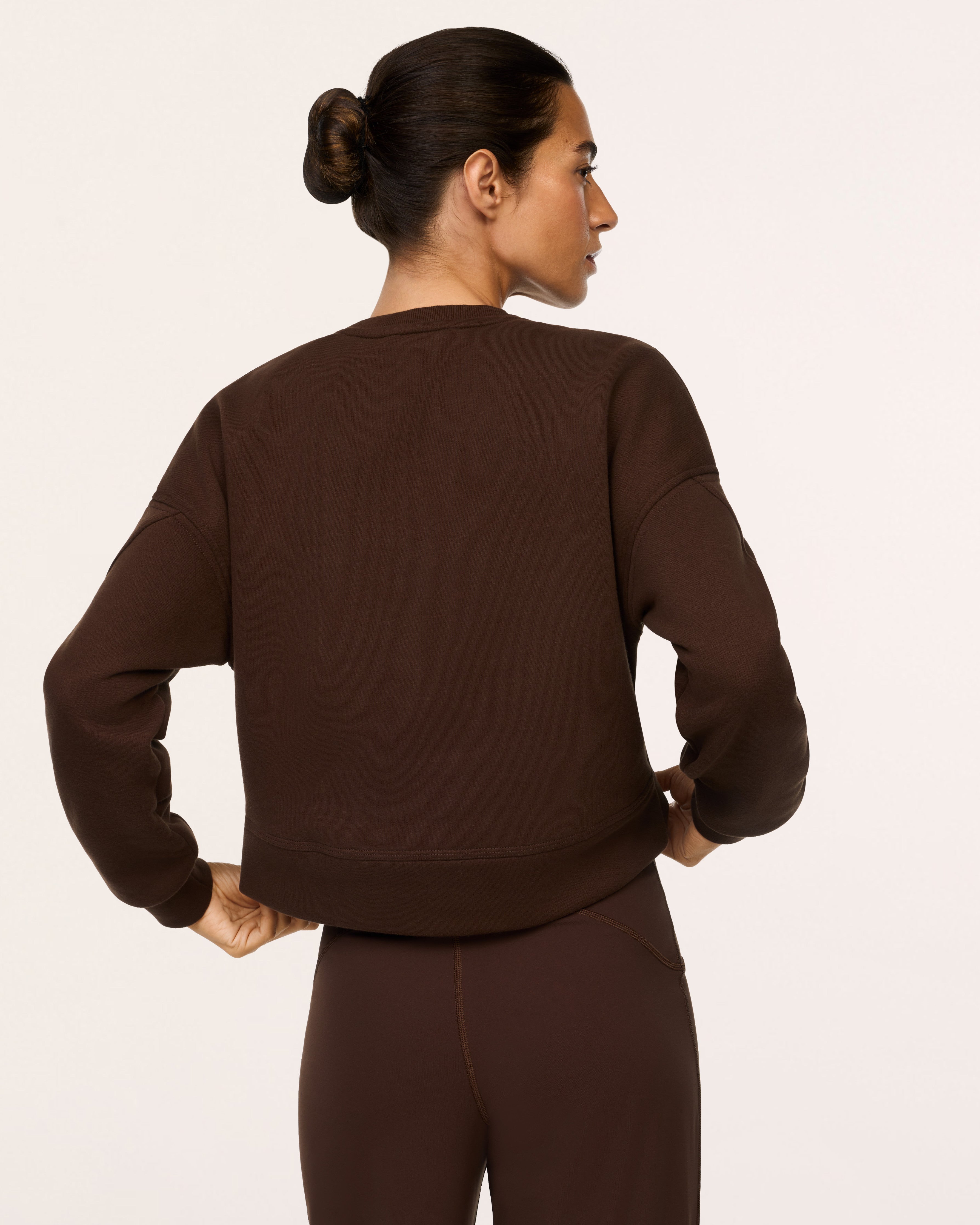 SPANX Cotton Fleece Crewneck in Umber Root brown, back view with dropped shoulders and banded hem