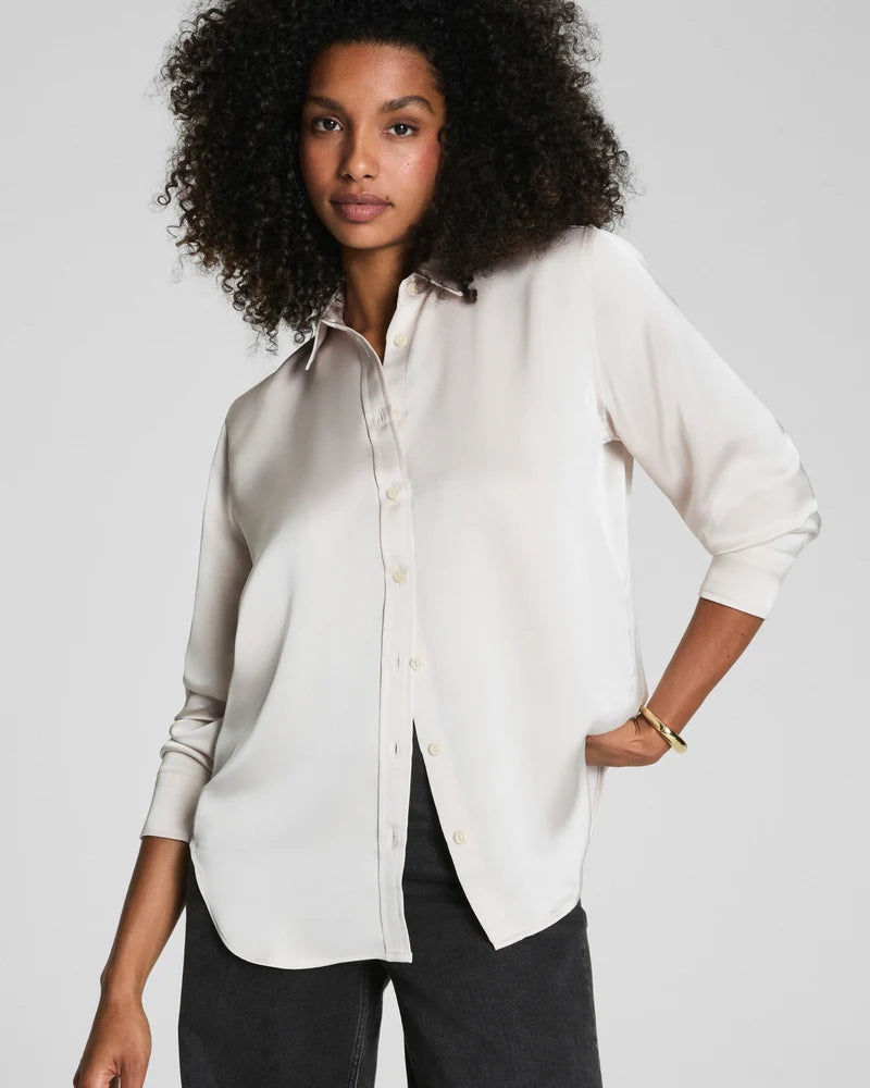 SPANX Silky Smooth Button Down in Birch soft ivory with black pants, relaxed-yet-tailored fit, front view